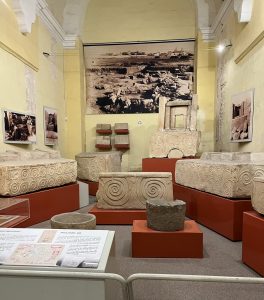 Display of various stone pieces in National Museum of Archeology, Valletta
