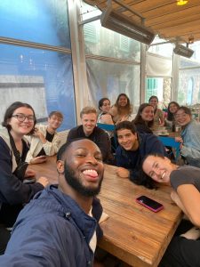 Victory taking a selfie with the rest of the Butler in Spain group sitting down at lunch tables