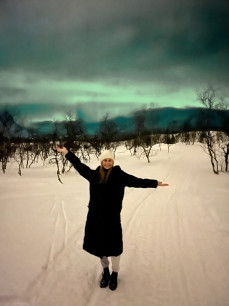 Belle Echeverria posing in front of the Northern Lights