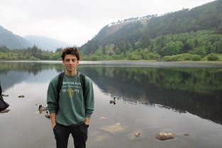 Ben Johovich standing in front of Glendalough in Wicklow, Ireland